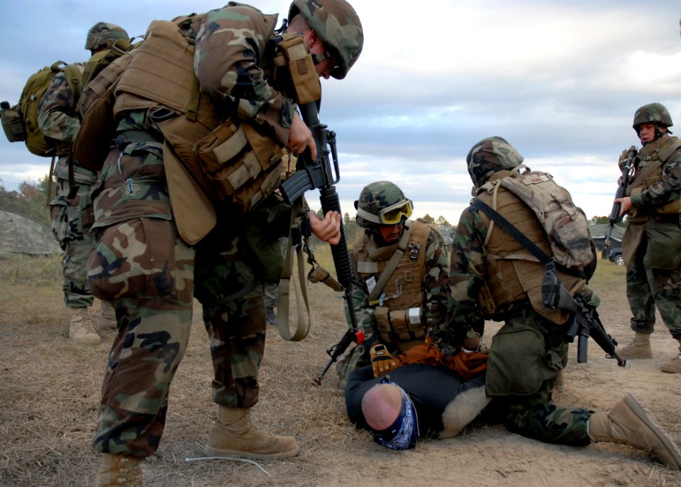 US Navy 081106-N-3857R-012 Seabees assigned to the Naval Mobile Construction Battalion (NMCB) 1 quick reaction force secure a hostile camp intruder with zip ties