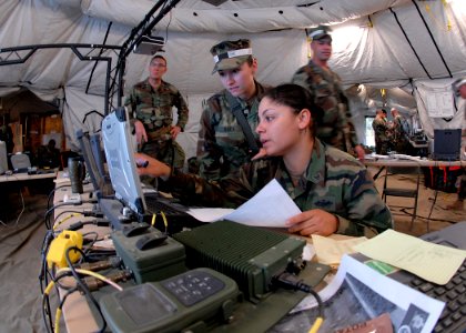 US Navy 081106-N-3857R-013 Yeoman 3rd Class Danellie Rivera, assigned to Naval Mobile Construction Battalion (NMCB) 1, stands watch in the Battalion's Combat Operations Center