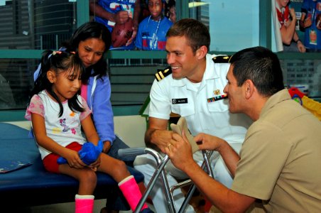 US Navy 081106-N-8390S-083 Lt. Andrew Baldwin, M.D., assigned to the Navy Bureau of Medicine and Surgery, visits children and passes out Navy teddy bears at the Shriners Hospital