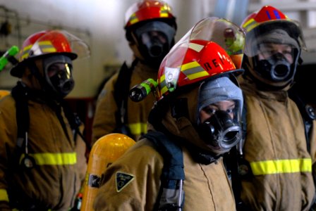 US Navy 081107-N-1635S-004 Fully dressed out in firefighting gear, Reactor Department personnel stand by for orders during a nuclear power mobile training team (NPMTT) drill aboard the Nimitz-class aircraft carrier USS Ronald R