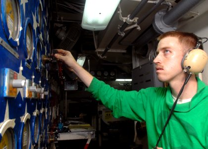 US Navy 081104-N-2456S-100 Aviation Boatswain's Mate (Equipment) 2nd Class Kevin Heaton, from Atkins, Ark., adjusts the air pressure on the central target panel of catapult four aboard aircraft carrier USS Theodore Roosevelt (C