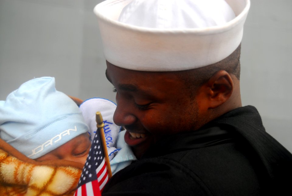 US Navy 081104-N-5148B-059 Aviation Boatswain's Mate Airman Darien Matthews meets his son for the first time after returning from a six-month deployment