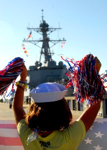 US Navy 091204-N-0209M-002 A young family member cheers as USS Wayne E. Meyer (DDG 108) arrives at its new homeport of San Diego