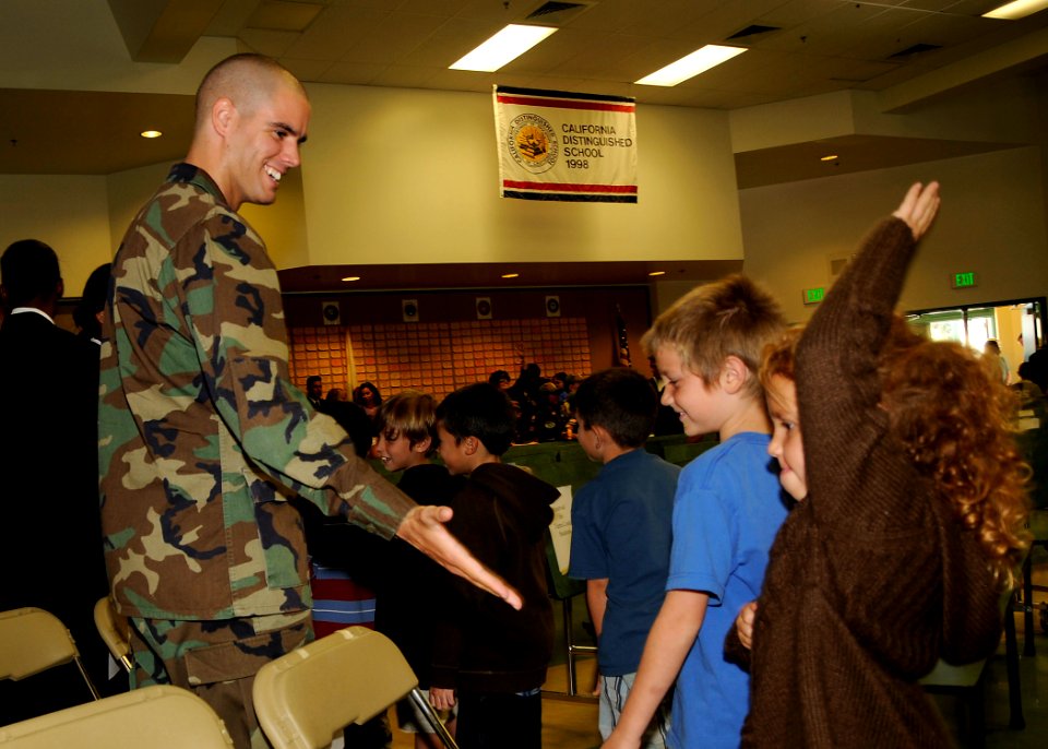 US Navy 081107-N-9584H-023 A Seabee from Naval Mobile Construction Battalion (NMCB) 3 greets a student at Tierra Linda Elementary School