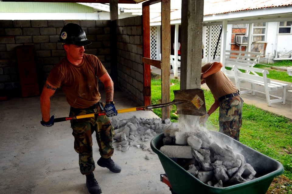 US Navy 081111-N-4515N-035 Builder 2nd Class Sean Roberts removes a broken block wall before starting construction work at a local hospital photo