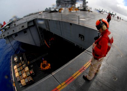 US Navy 081107-N-1038M-049 Aircraft carrier USS George Washington's (CVN 73) air gunner, Chief Warrant Officer Steven Miller, watches as Aviation Ordnancemen load ammunition onto an elevator
