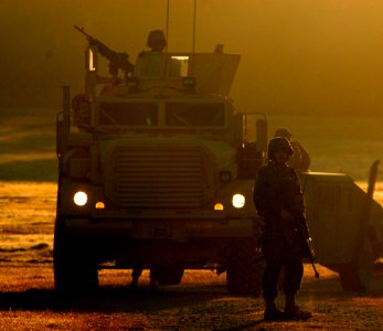 US Navy 081108-N-7367K-003 A Seabee assigned to Naval Mobile Construction Battalion (NMCB) 1 guides a convoy onto camp