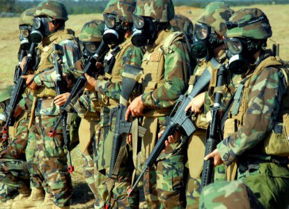 US Navy 081111-N-7367K-004 Naval Mobile Construction Battalion (NMCB) 1 Seabees assigned to the quick reaction force ready themselves for a group of simulated rioters near the entry control point of forward operating base 1