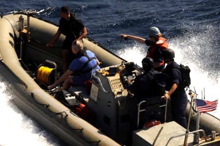 US Navy 091117-N-9500T-206 A boat crew from USS Chosin (CG 65) launches a rigid hull inflatable boat to rescue three men