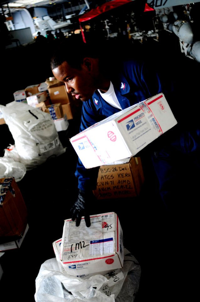 US Navy 081111-N-7918H-029 Postal Clerk 3rd Class Blaine Character organizes the mail for the crew of the aircraft carrier USS Theodore Roosevelt (CVN 71)