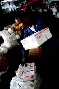 US Navy 081111-N-7918H-029 Postal Clerk 3rd Class Blaine Character organizes the mail for the crew of the aircraft carrier USS Theodore Roosevelt (CVN 71)