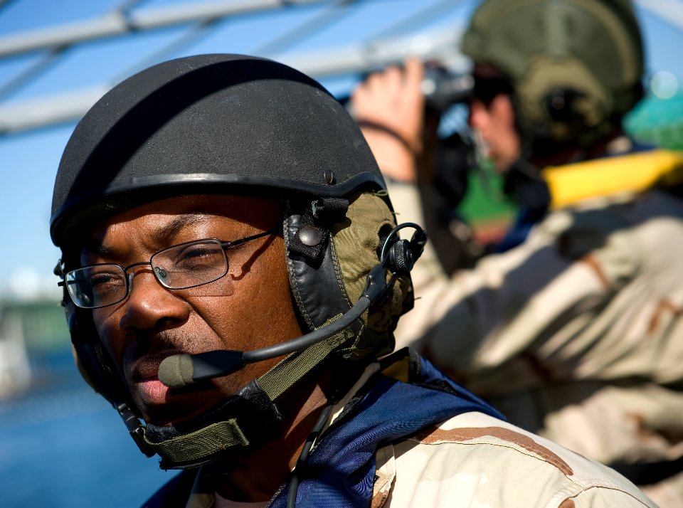 US Navy 081107-N-6932B-396 Engineman 2nd Class Kpaku Palay assigned to Boat Division 56, a detachment of Maritime Expeditionary Security Squadron (MESRON) 1, relays surface contact information to his patrol leader