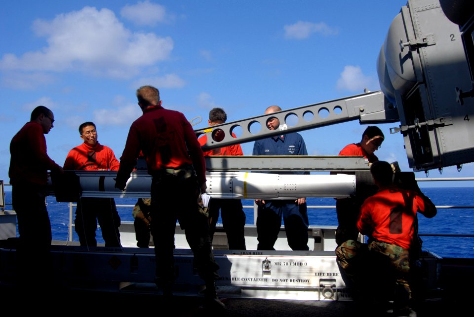 US Navy 081112-N-7730P-035 ire controlmen from combat systems department, CS-7 Division aboard the Nimitz-class aircraft carrier USS Ronald Reagan (CVN 76) lower a Sea Sparrow missile into a storage and transport case