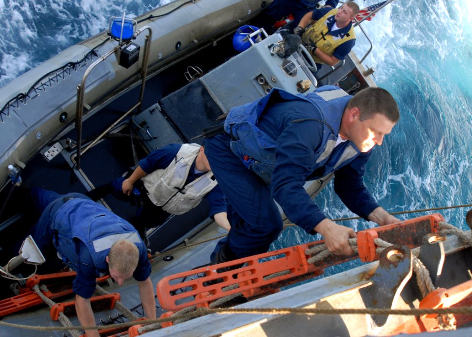 US Navy 081108-N-9900B-004 Boatswain's Mate 2nd Class Keith Sembrat climbs back aboard the guided-missile cruiser USS Monterey (CG 61) after a boat officer training evolution