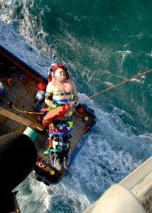 US Navy 081112-N-9620B-012 Team members from Helicopter Sea Combat Squadron (HSC) 28, Detachment 5 embarked aboard the amphibious assault ship USS Kearsarge (LHD 3) hoist a Norwegian man during a search and rescue medical evacu