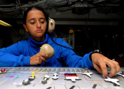 US Navy 081108-N-2456S-175 Aviation Boatswain's Mate (Handling) Juciara Bramusse, from Minas Gerais, Brazil, assigns aircraft to the ouija board in Flight Deck Control as they taxi the flight deck aboard the aircraft carrier US