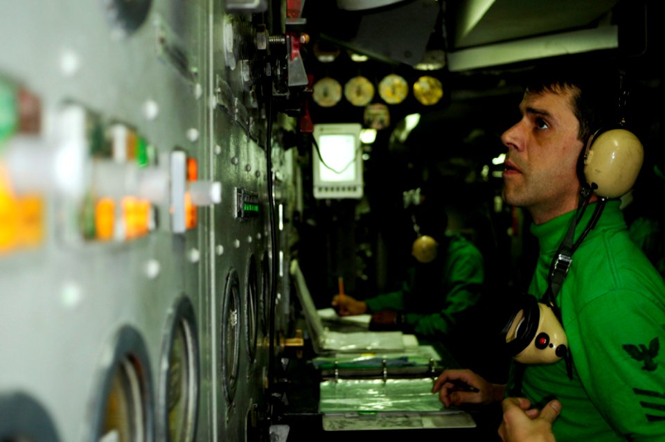 US Navy 081110-N-7918H-003 Aviation Boatswains Mate (Equipment) 1st Class Tony Pavao checks the gauges on catapult one