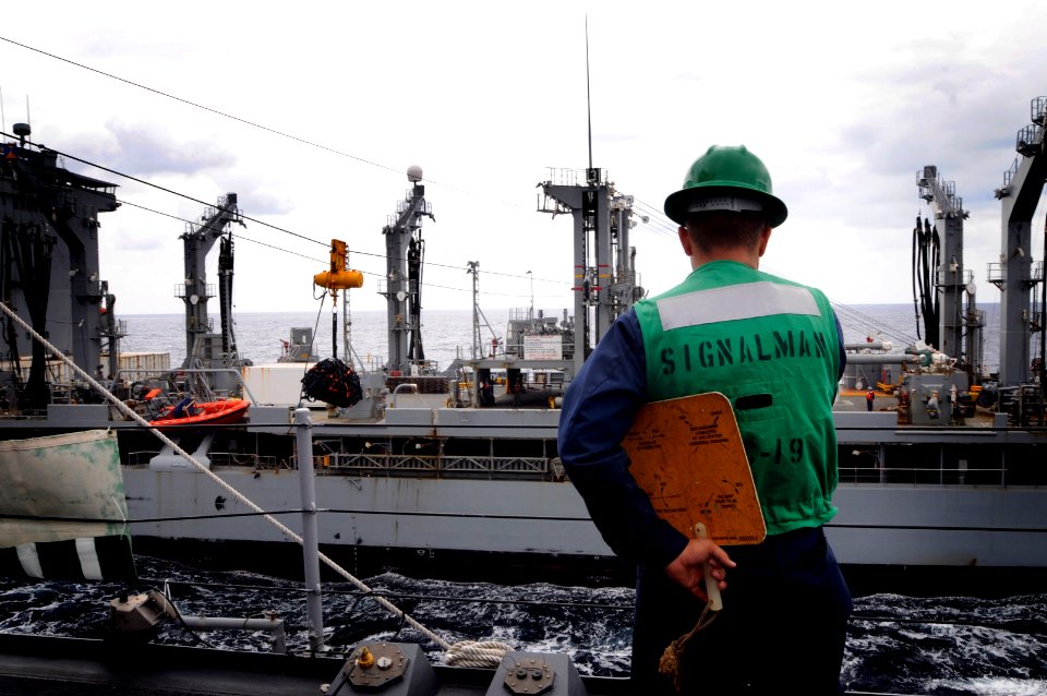 US Navy 090920-N-3830J-170 Seaman Jon-Michael Berg signals the military sealift command fleet replenishment oiler USNS John Ericsson (T-AO 194)