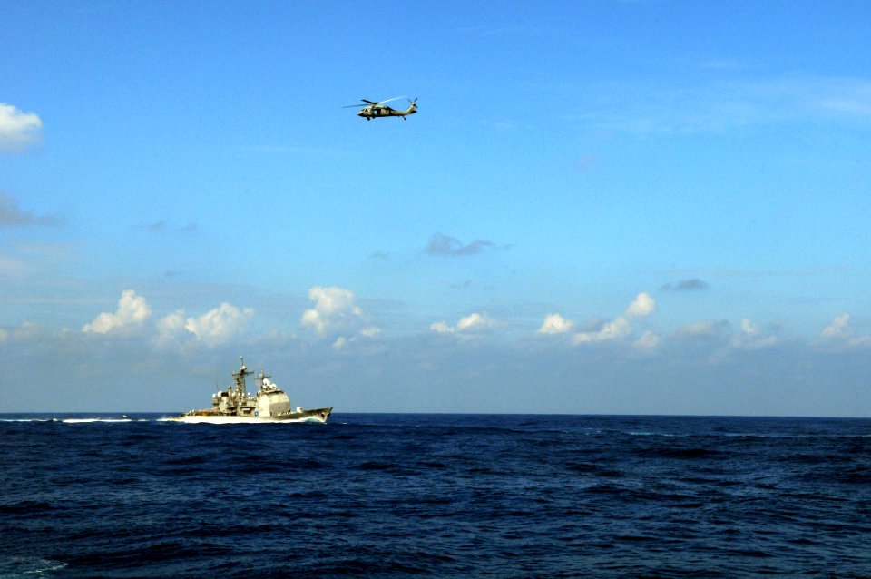 US Navy 081114-N-3659B-426 An MH-60S Sea Hawk flies past the Ticonderoga-class guided-missile cruiser USS Chancellorsville (CG 62) during a vertical replenishment