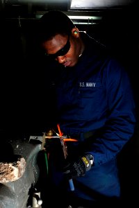 US Navy 100106-6604E-N-054 Hull Maintenance Technician Fireman Devonish Murphy repairs a broken faucet