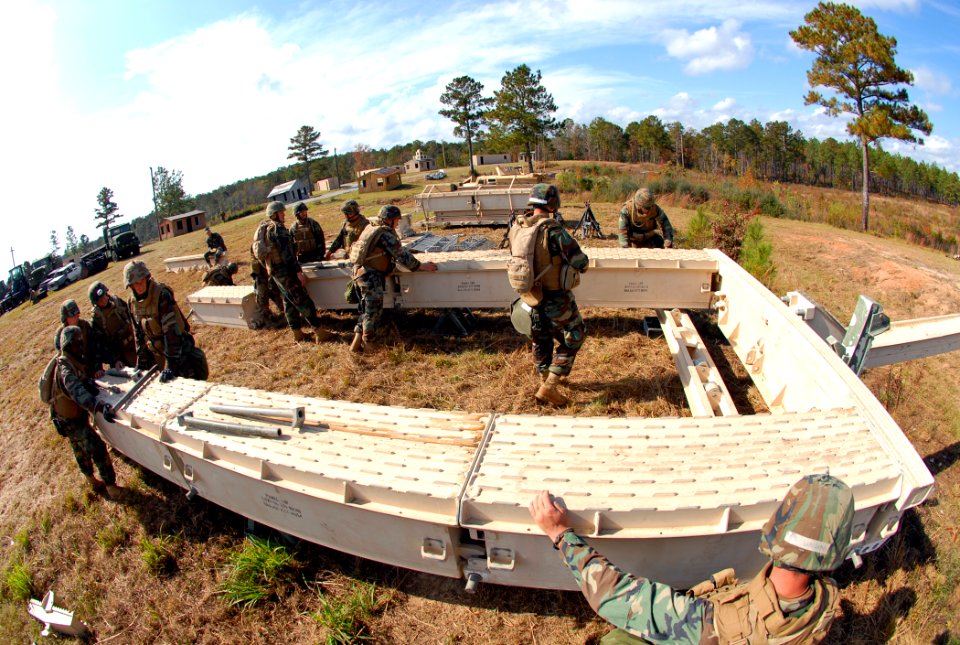 US Navy 081114-N-7367K-028 Seabees work together to launch a medium girder bridge