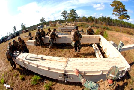 US Navy 081114-N-7367K-028 Seabees work together to launch a medium girder bridge