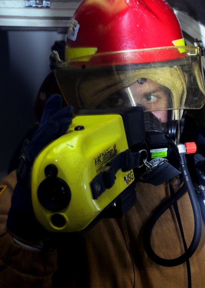 US Navy 081113-N-9758L-046 Hull Technician 3rd Class Thomas Mills, assigned to the Pearl Harbor-based Arleigh Burke-class guided-missile destroyer USS Paul Hamilton (DDG 60), uses an aqueous film forming foam bottle to fight a