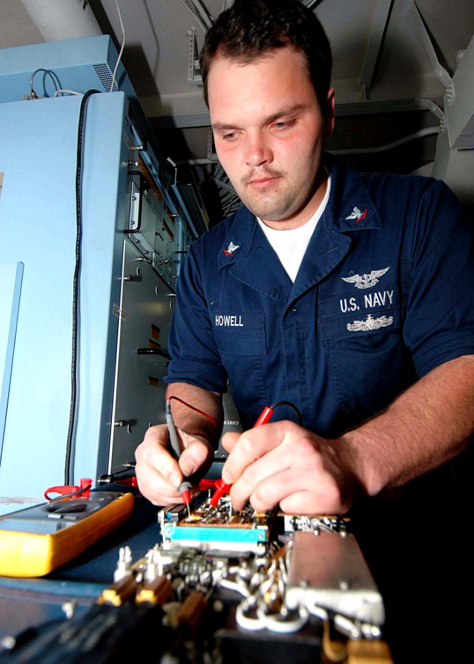 US Navy 081112-N-1062H-005 Aviation Electronics Technician 3rd Class Anthony Howell performs a continuity check on a circuit card assembly