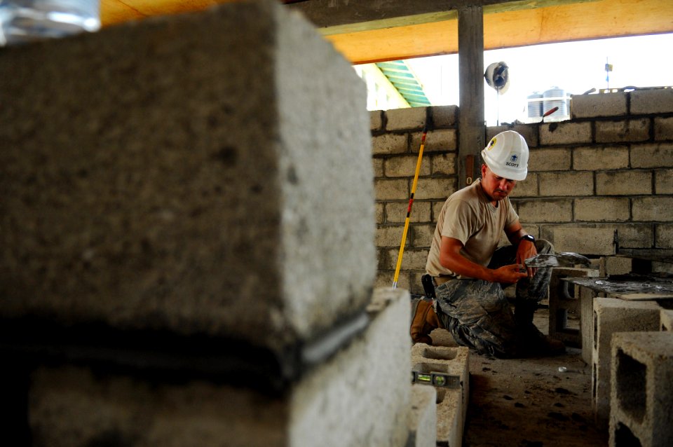 US Navy 081114-N-4515N-057 Master Sgt. Roger Scott, an engineer embarked aboard the amphibious assault ship USS Kearsarge (LHD 3), builds a block wall for a new canteen at West Demarara Regional Hospital