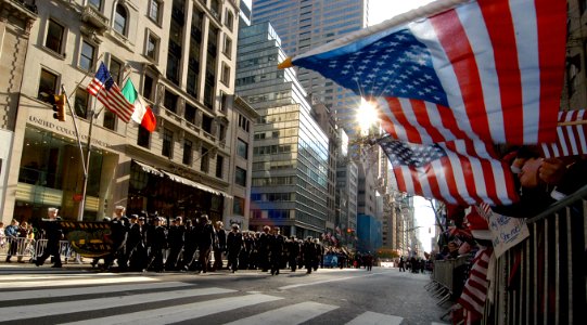 US Navy 081111-N-2636M-213 Parade onlookers wave American flags and signs as Sailors assigned to the multi-purpose amphibious assault ship USS Bataan (LHD 5) march in the annual New York Veterans Day parade