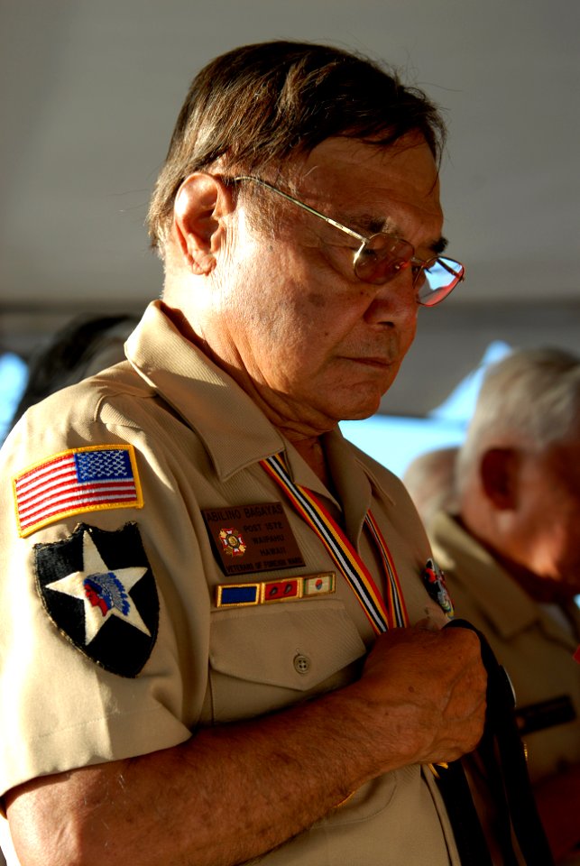 US Navy 081111-N-5476H-020 Abilino Bagaya of the Veterans of Foreign Wars Post 1572 Waipahu, Hawaii, bows his head for a moment of silence during a Veterans Day sunset service