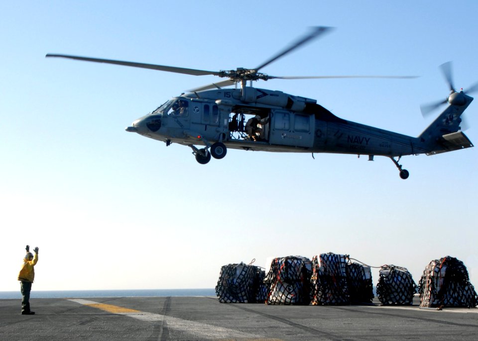 US Navy 081114-N-9900B-004 An MH-60S Sea Hawk transports supplies to the Nimitz-class aircraft carrier USS Theodore Roosevelt (CVN 71)