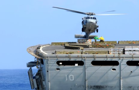 US Navy 081114-N-3659B-115 An MH-60S Sea Hawk prepares to transfer a group of cargo pendants from the Military Sealift Command fast combat support ship USNS Bridge (T-AOE 10)