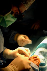 US Navy 081115-N-7544A-088 Cmdr. Brian Alexander, an ophthalmologist embarked aboard the amphibious assault ship USS Kearsarge (LHD 3), performs eye surgery on a 3-year-old girl photo