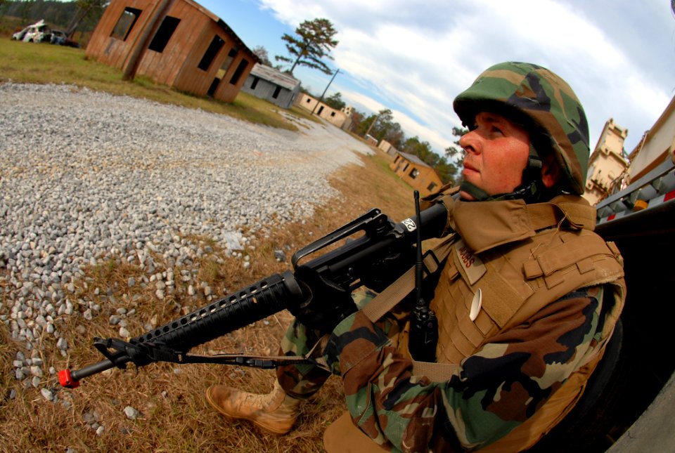 US Navy 081114-N-7367K-010 Builder 1st Class Nathan Jacobs searches for enemy activity during a security sweep of a bridge site