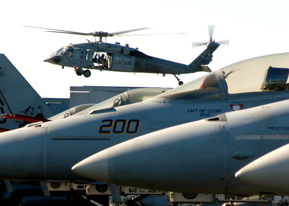 US Navy 081114-N-9900B-008 An MH-60S Seahawk ransports supplies to the Nimitz-class aircraft carrier USS Theodore Roosevelt (CVN 71)
