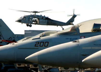 US Navy 081114-N-9900B-008 An MH-60S Seahawk ransports supplies to the Nimitz-class aircraft carrier USS Theodore Roosevelt (CVN 71)