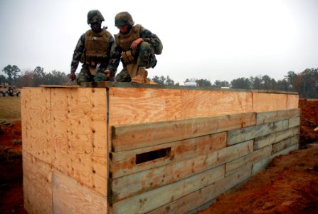 US Navy 081113-N-7367K-005 Steelworker Constructionman Recruit Nicholas Woodruff and Builder Constructionman Apprentice Domonic Fitzpatrick work together to help build a timber bunker