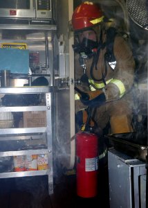 US Navy 081113-N-9758L-041 A Sailor assigned to the Pearl Harbor-based Arleigh Burke-class guided-missile destroyer USS Paul Hamilton (DDG 60) investigates smoke during a fire drill aboard the ship