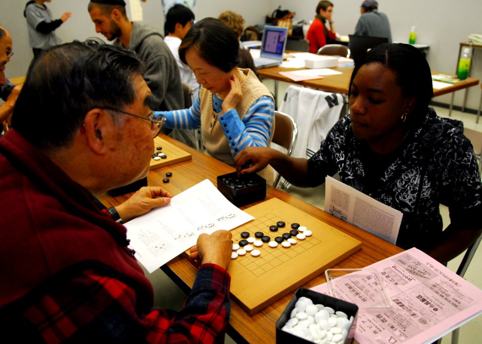 US Navy 081116-N-2013O-005 Mass Communication Specialist Seaman Apprentice Gabrielle Blake learns how to play the traditional Japanese board game Igo