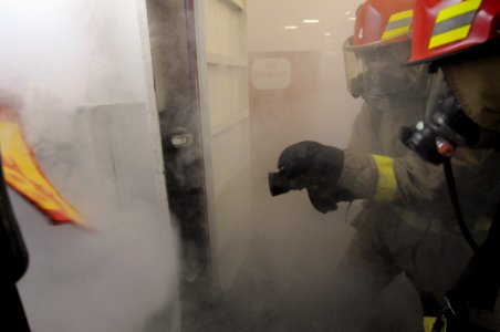 US Navy 081114-N-3659B-510 Sailors assigned to Repair Locker 1F battle a simulated class Bravo fire in a fuel station in hangar bay one during a general quarters drill aboard the aircraft carrier USS Ronald Reagan (CVN 76)