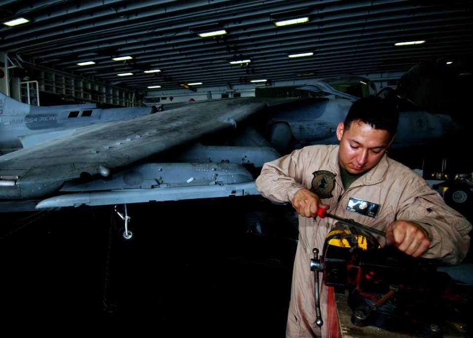 US Navy 081114-N-4236E-046 Staff Sgt. Ruben Diaz from Marine Medium Helicopter Squadron (HMM) 264 performs maintenance on an AV-8B Harrier aboard the multi-purpose amphibious assault ship USS Iwo Jima (LHD 7)