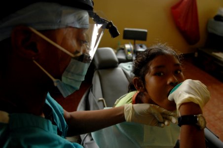 US Navy 081116-N-7544A-105 Tech Sgt. Carletta James, an Air Force dental assistant embarked aboard the amphibious assault ship USS Kearasrge (LHD 3), gives a patient a cup of water photo