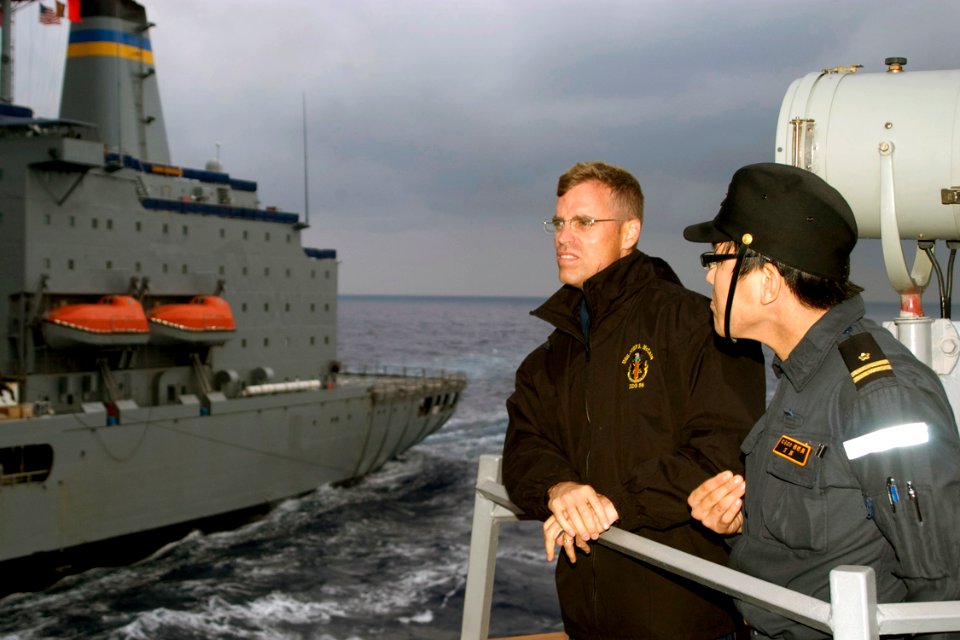 US Navy 081117-N-9123L-002 Lt. Cmdr. Robert Ogden and Lt. Daisuke Mihara, gun officer aboard the Japan Maritime Self-Defense Force destroyer Murasame (DD 101), observe an underway replenishment