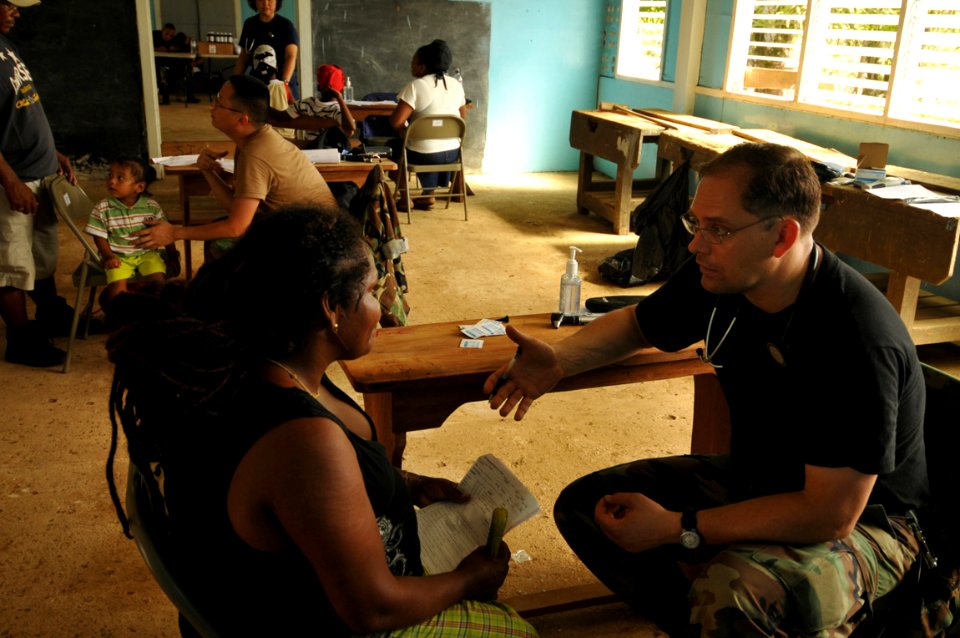 US Navy 081117-N-8907D-203 U.S. Public Health Service Lt. Cmdr. Ken Norris consults with a patient during medical operations at the Port Kaituma Skills Training Centre during Continuing Promise 2008
