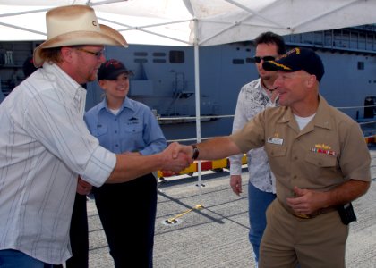 US Navy 081118-N-0515W-018 Country music singer and songwriter Tracy Lawrence is greeted by Capt. Neil Parrott, commanding officer of the amphibious assault ship USS Bonhomme Richard (LHD 6)