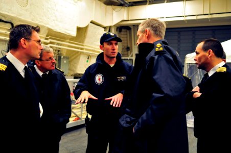 US Navy 081121-N-5758H-331 Lt. Cmdr. Rich Jarrett explains features of the hangar bay aboard the littoral combat ship USS Freedom (LCS 1) to Canadian navy personnel during a tour of the ship's spaces photo