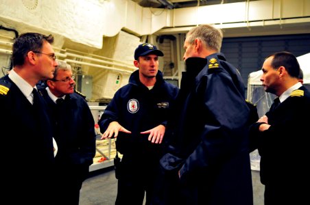 US Navy 081121-N-5758H-331 Lt. Cmdr. Rich Jarrett explains features of the hangar bay aboard the littoral combat ship USS Freedom (LCS 1) to Canadian navy personnel during a tour of the ship's spaces