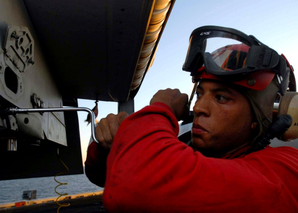 US Navy 081119-N-2456S-063 Aviation Ordnanceman Airman Robert Davis uninstalls breaches of a pylon on an F-A-18E Super Hornet