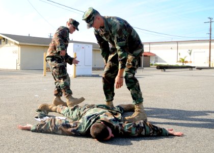 US Navy 081121-N-9584N-005 Construction Electrician 3rd Class Meghan Cox and Construction Electrician Constructionman Steven Gawlas search Construction Electrician 3rd Class Travis Walker during an immediate action drill